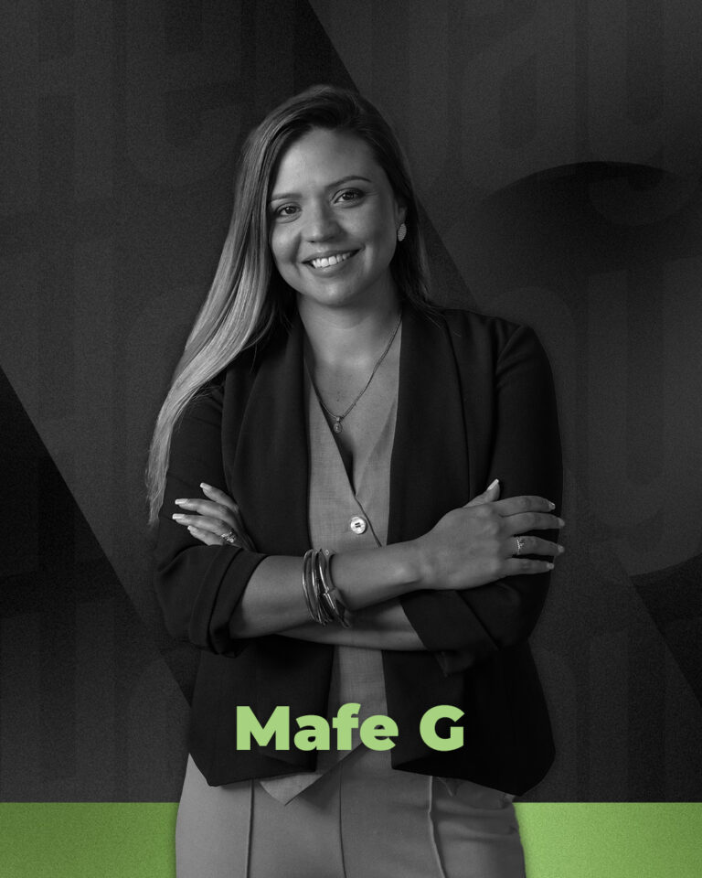 Woman in business attire smiling with arms crossed. Text: "Mafe G" at the bottom.